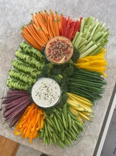 a platter with carrots, celery, broccoli and other vegetables