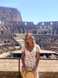 a woman standing in front of the colossion with her hand on her hip