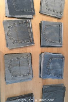 several pieces of denim sitting on top of a wooden table