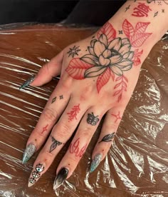 a woman's hand with tattoos on it