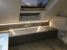 a bathroom with a skylight above the bathtub