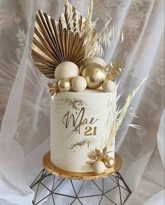 a white cake with gold decorations on top