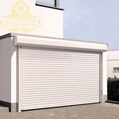 a white building with a closed garage door