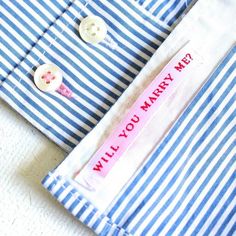 a blue and white striped shirt with a pink label on it that says sam yam you luv