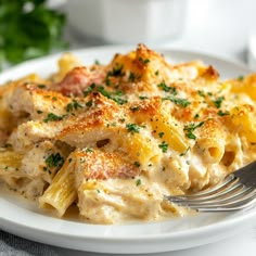 a white plate topped with pasta covered in sauce