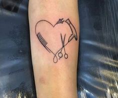 a heart with scissors and a hairbrush on it's arm is shown in black ink