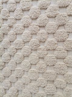 a close up view of a white rug