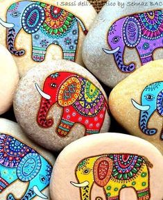 some rocks with painted elephants on them