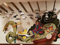 an artistic mural on the wall of a restaurant