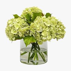 a vase filled with green flowers on top of a table