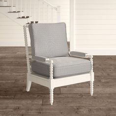 a white chair sitting on top of a hard wood floor