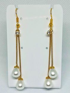 A beautiful hanging pearl earrings with gold hook and stone. Perfect with any dress and occasion. Elegant Pearl Embellished Dangle Chandelier Earrings, Pearl Drop Dangle Crystal Earrings, Elegant Jewelry With Dangling Beads, White Gold Plated Pearl Earrings For Party, Party Pearl Chain Drop Earrings, Elegant Drop Pearl Earrings With Dangling Beads, Elegant Teardrop Pearl Earrings With Dangling Beads, Gold Pearl Drop Danglers, Elegant Teardrop Jewelry With Dangling Beads