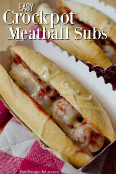 two crockpot meatball subs sitting on top of a white paper plate