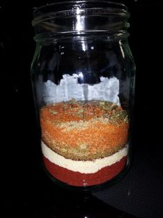 a jar filled with food sitting on top of a counter next to a black table