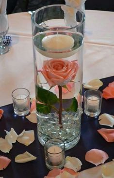 a vase filled with water and flowers on top of a table