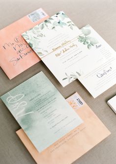 the wedding stationery is laid out on top of each other