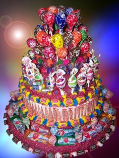 a multi layer candy cake with lots of candies on top