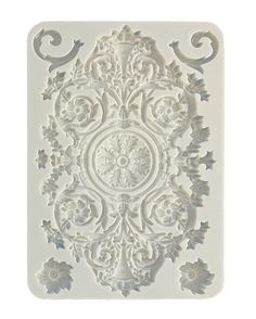 an intricately designed design is shown on the back of a white plastic molder