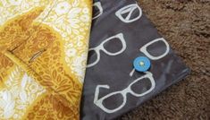 two pieces of cloth with eyeglasses on them sitting next to eachother