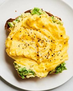 an egg and avocado sandwich on a white plate