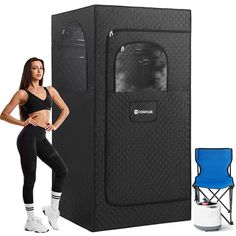 a woman standing next to a black portable shower