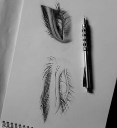 a pencil drawing of an eye and some other things on the paper next to it