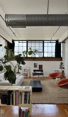 a living room filled with furniture and lots of windows