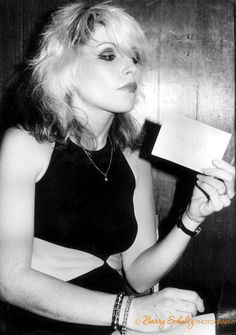 black and white photograph of a woman holding a piece of paper