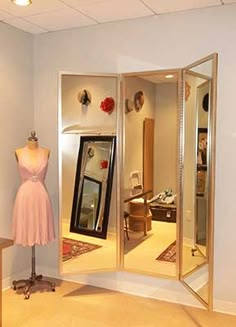 a mannequin is standing in front of an open closet with dresses on display