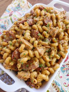 a white dish filled with pasta and meat