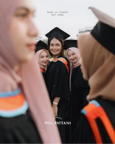 a group of young women standing next to each other wearing graduation gowns and caps