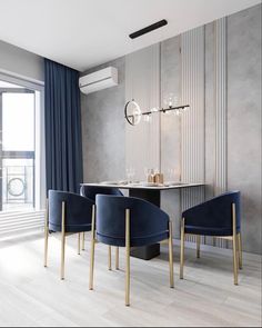 an elegant dining room with blue velvet chairs