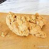 a piece of food that is on top of a cutting board next to a knife