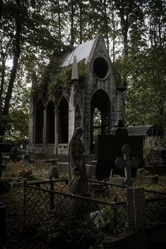 an old cemetery with a statue in the foreground