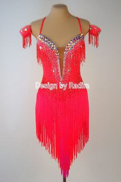 a red dress with fringes and beads on the shoulders is displayed in an instagramtion