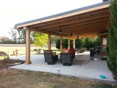 an outdoor covered patio with chairs and tables