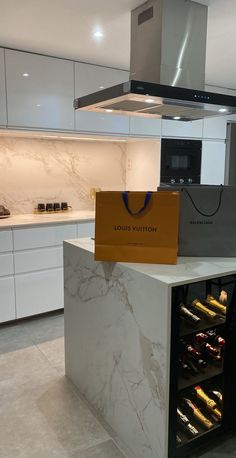 a kitchen with marble counter tops and an oven in the center, surrounded by white cabinets