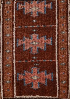 an old rug with blue and red designs on it