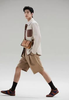 a man walking while carrying a brown bag