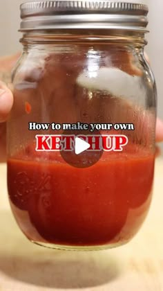 a person holding a jar filled with ketchup