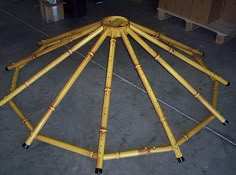 a group of bamboo poles sitting on top of a cement floor