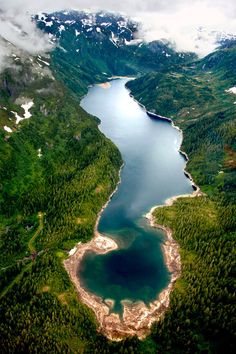 an aerial view of a lake surrounded by mountains