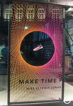 a window display with an orange and pink design