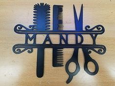 scissors and combs are hanging on a wooden wall with the word hand written in it