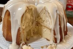 a bundt cake with white icing sitting on top of a white platter