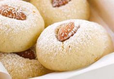 powdered sugar cookies with almonds in a basket