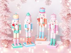 three nutcrackers are standing next to each other in front of christmas trees