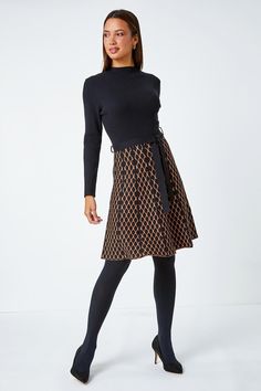 Contrast Skirt Knit Jacquard Dress from Roman. Perfect for the cooler season ahead, this contrast knit dress is crafted from a soft ribbed fabric. It features a cosy high neckline and long sleeves for a trendy finish. This dress is designed with a panelled, printed skirt which falls to an everyday knee-length in a flattering fit and flare style. Finished with a self-tie fabric belt, this is perfect paired with tights, boots and a fluffy gilet for an everyday Autumn look! Chic Fitted Pointelle Knit Skirt, Stretch Mini Dress With Lined Skirt, Chic A-line Knit Dress, Workwear Midi-length Dress With Lined Skirt, Workwear Midi Dress With Lined Skirt, Midi Length Workwear Dresses With Lined Skirt, Flared Skirt Dresses For Work In Fall, Fall Midi Dress With Lined Skirt, Chic Textured Knit Fitted Dress