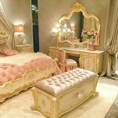 a fancy bedroom with pink and gold furniture in the middle, along with mirrors on the wall