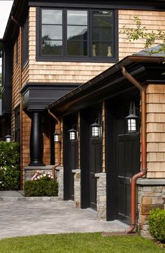 an instagram photo of a house with black doors and windows on the front porch